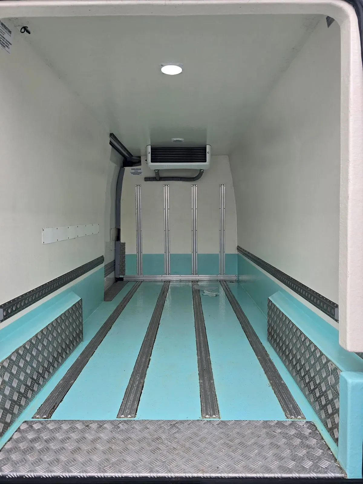 Clean refrigerated van interior for temperature-controlled courier deliveries