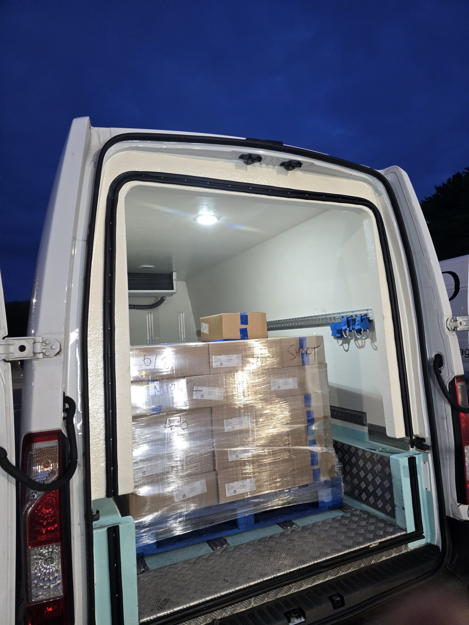 Refrigerated van interior transporting chilled food products under temperature-control